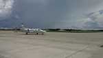 The aircraft sits idle on the ground at the Space Coast Regional Aircraft while a thunderstorm passes through the area.